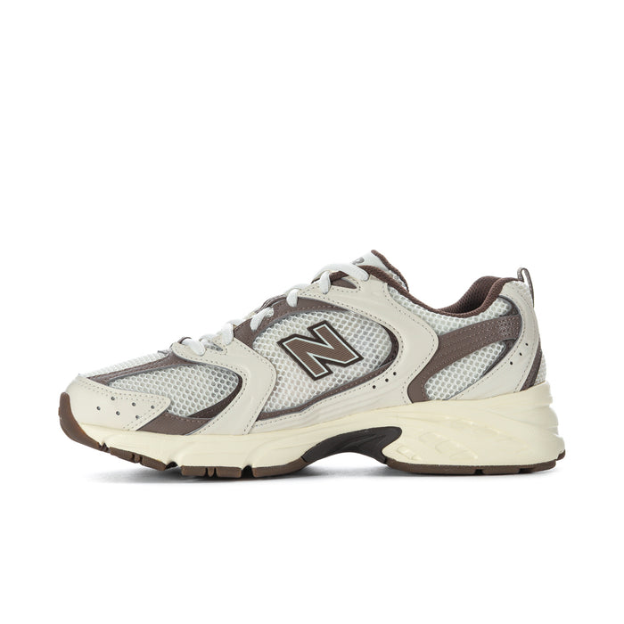 Back view of lace-up sneakers with cream heel, gray mesh, brown collar and pull tab