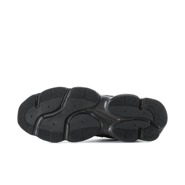 Black athletic sneaker outsole, textured tread bottom view