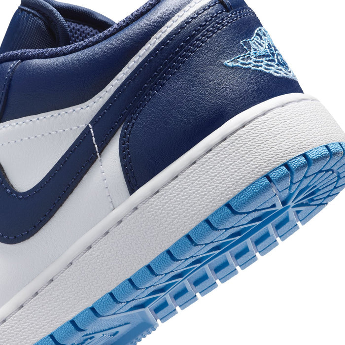Navy and white youth sneaker side detail with Air Jordan logo and blue outsole