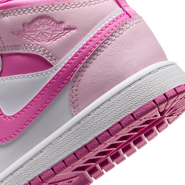 Kids' mid-top sneakers close-up, pink midsole and patterned outsole