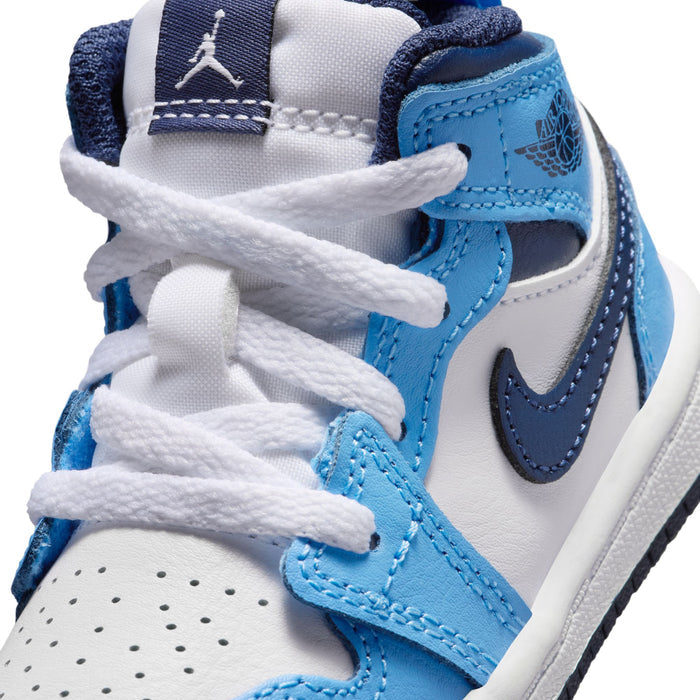 Close-up of toddler mid-top sneakers: white laces, light blue panels, navy swoosh