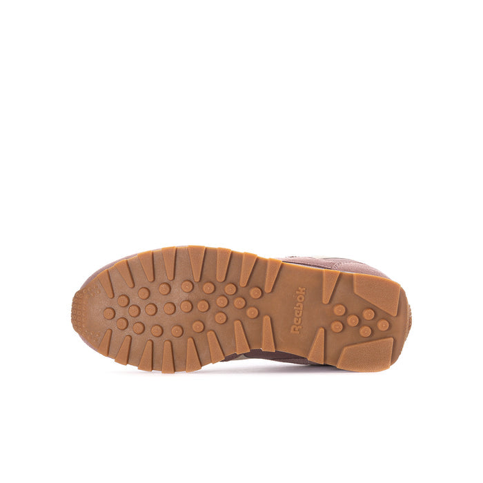 Youth sneaker outsole with brown traction tread and Reebok branding