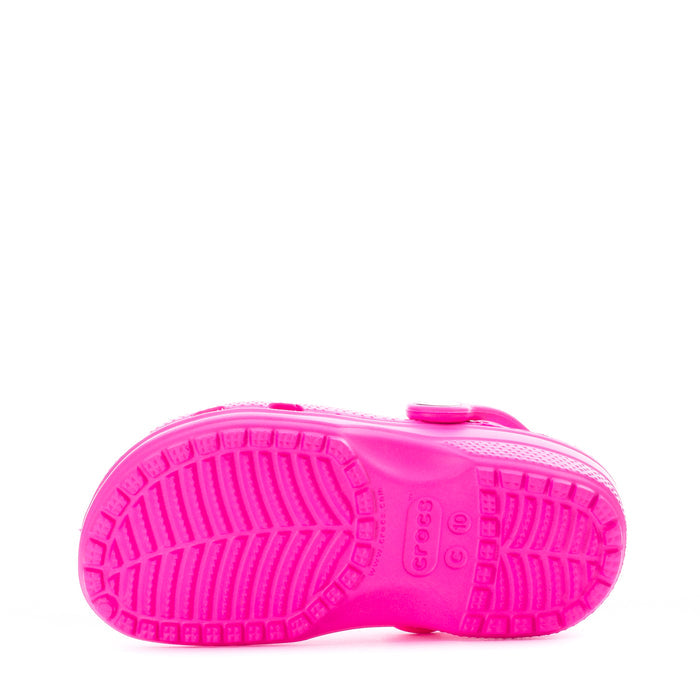 Bright pink toddler clog outsole with traction tread pattern.