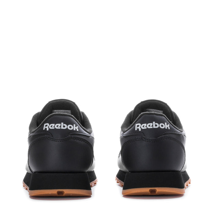 Youth black leather sneakers heel view with Reebok logo and gum sole