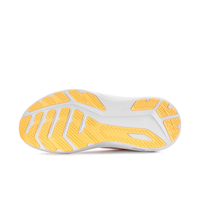 Shoe outsole tread with white base and orange/yellow rubber lugs for traction