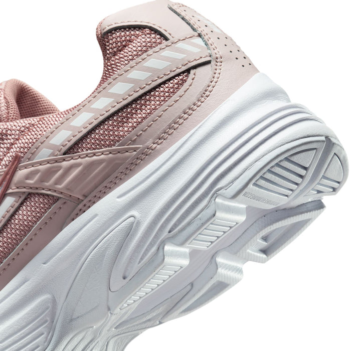 Close-up of white tread outsole ridges on dusty pink sneakers