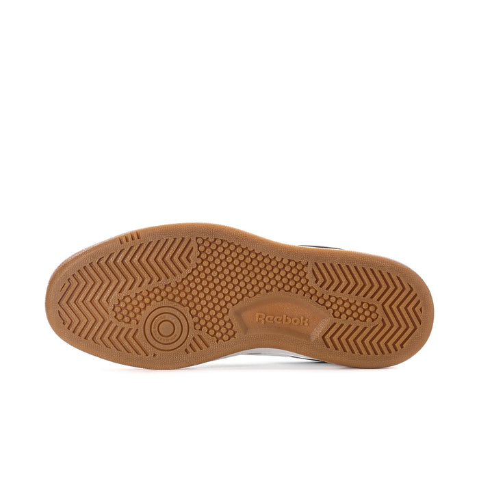 Women's sneaker outsole in tan gum with Reebok-marked traction pattern
