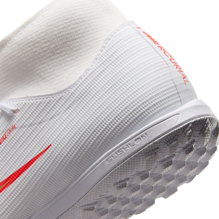 White Nike turf soccer cleat side with molded grip sole and red-orange swoosh