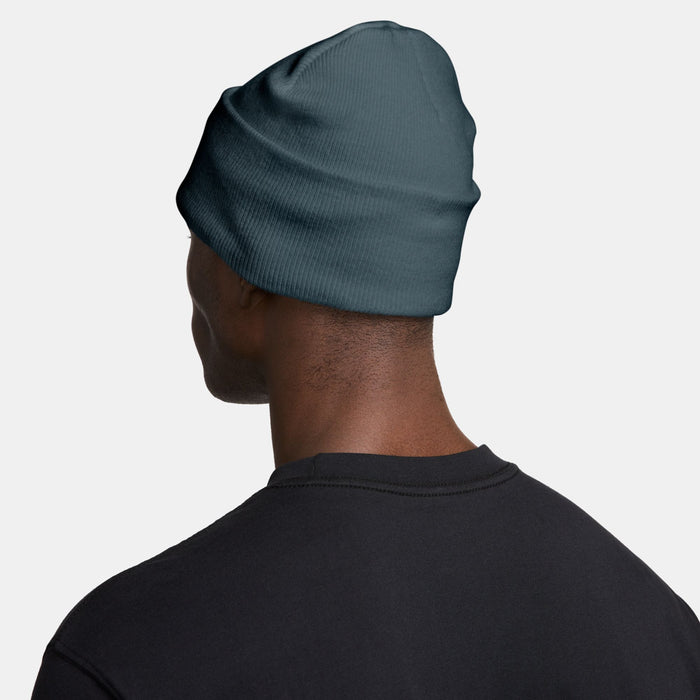 Nike beanie side view on model, dark teal knit with cuff
