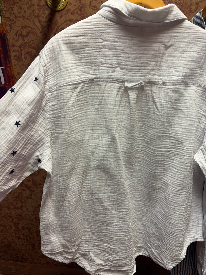 Camille & Co. Reach for the Stars blouse featuring a star print pattern and lightweight fabric, displayed on a hanger.