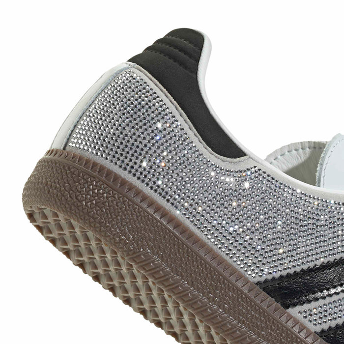 Close-up of heel and side: rhinestone upper, dark collar, and gum sole tread