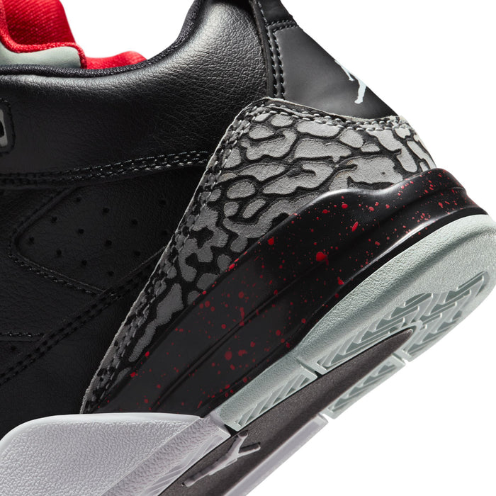 Close-up of kids sneaker side with elephant-print panel, red speckled detail, and sole