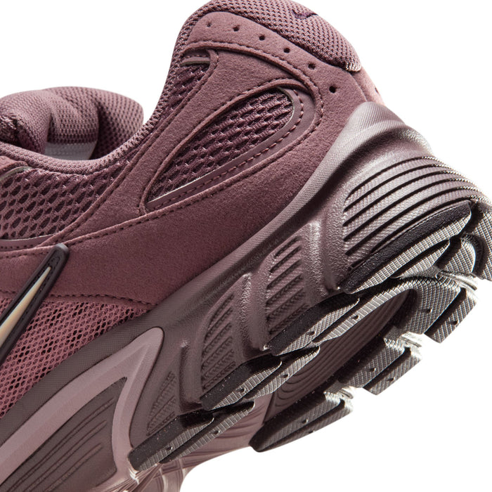 Men's sneaker side close-up in dusty mauve with mesh panel and rubber heel bumper