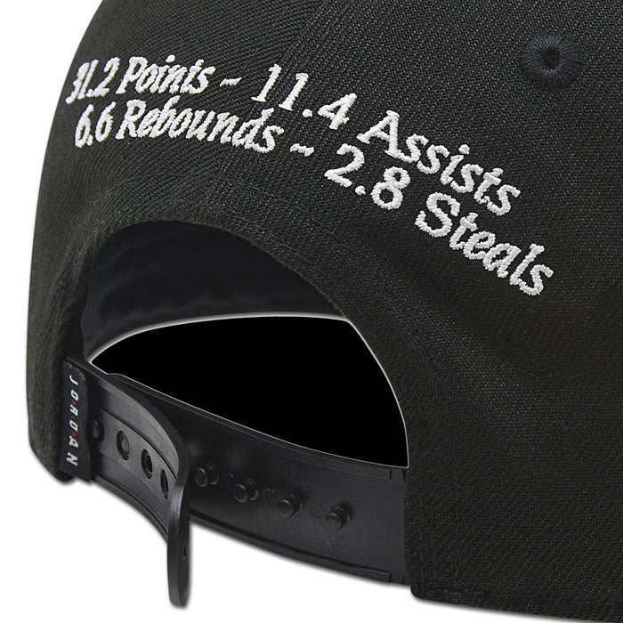 Black snapback cap close-up with white embroidered 11.4 Assists and 3.8 Steals text