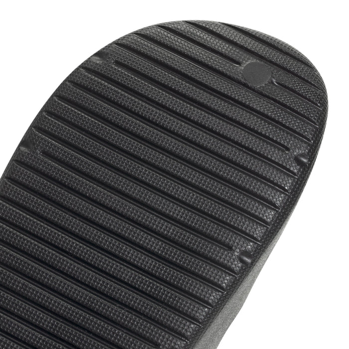 Black slide sandal outsole close-up with raised ribbed texture