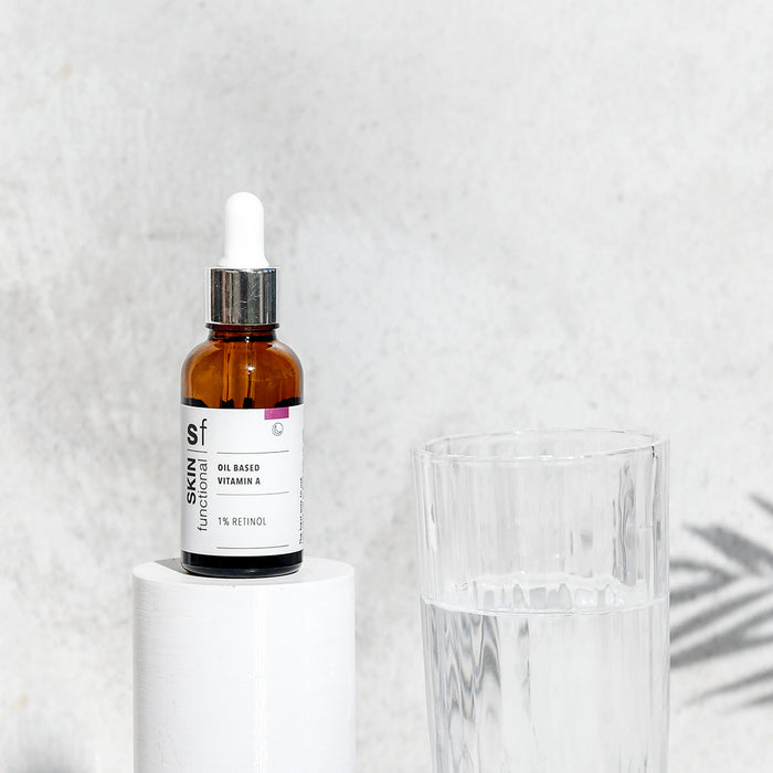 SKIN Functional Oil Based Vitamin A with details skincare product on a grey background