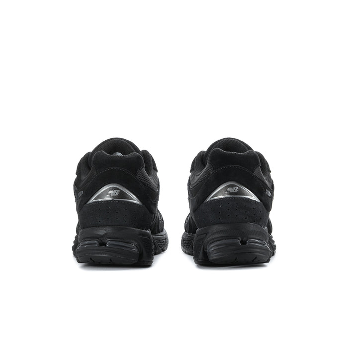 Men's black sneakers rear view with padded heel and textured rubber outsole