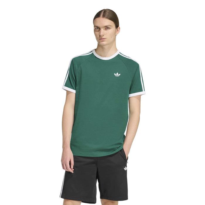 Men's green tee with white crew neck trim, small chest emblem, and three stripe shoulders