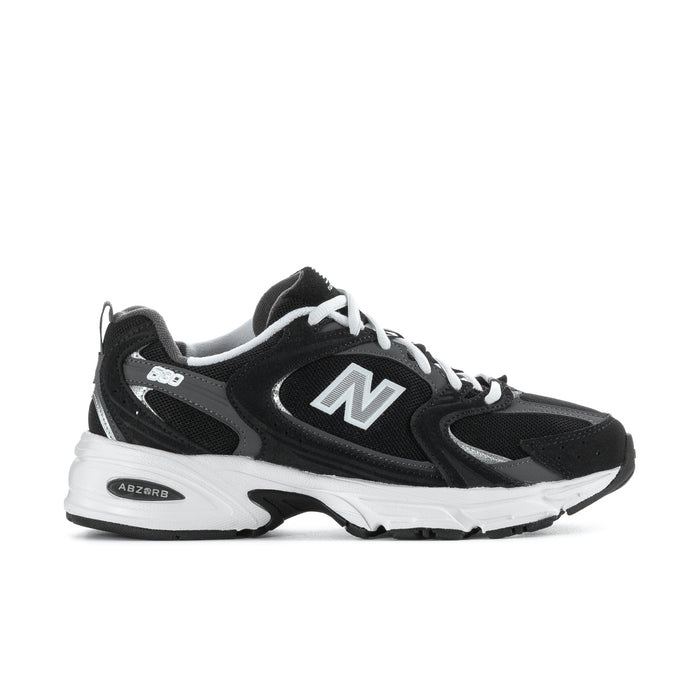 Wide women’s athletic sneakers in black with white sole and large N logo