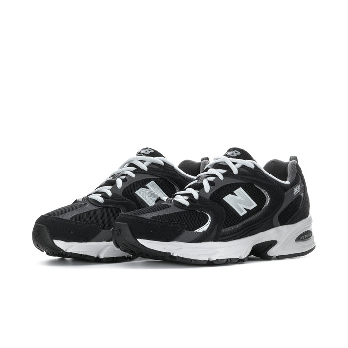Wide women’s athletic sneakers, side view in black with white sole and N emblem