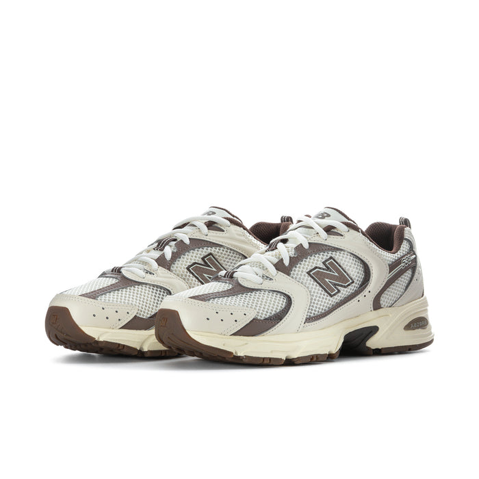Lace-up running shoe with cream suede panels, gray mesh overlays, brown detail