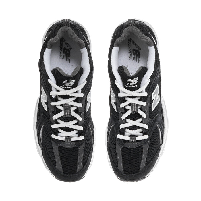 Wide women’s athletic sneakers, close front view with black uppers, white laces, N logo