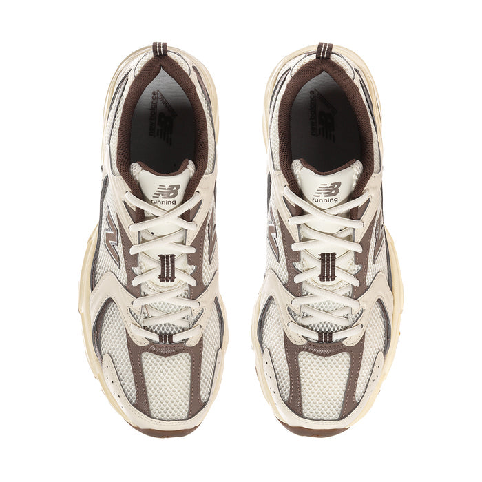 Pair of lace-up sneakers with N logo, cream uppers, gray mesh, brown outsole