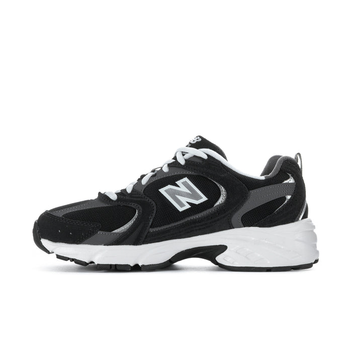 Wide women’s athletic sneakers, back view in black with white heel panel and laces