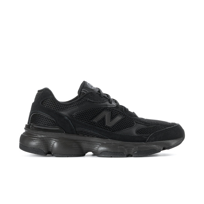 Black athletic sneaker with mesh upper, lace-up, and thick cushioned sole