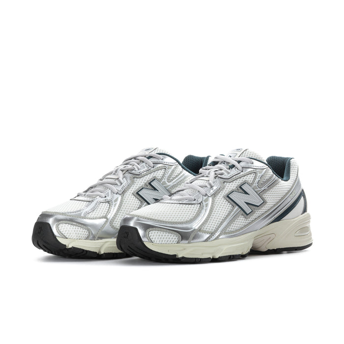 Men's athletic shoes, white metallic upper with teal N logo, lace-up and rubber sole
