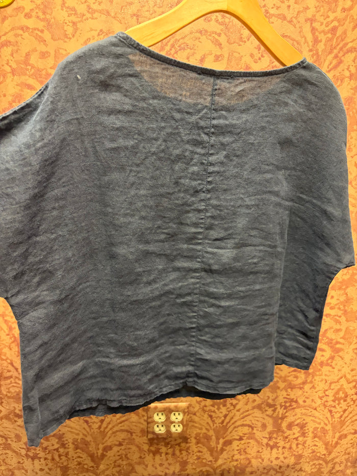 Light beige linen tee from Camille & Co. featuring a relaxed fit, short sleeves, and a classic crew neckline.