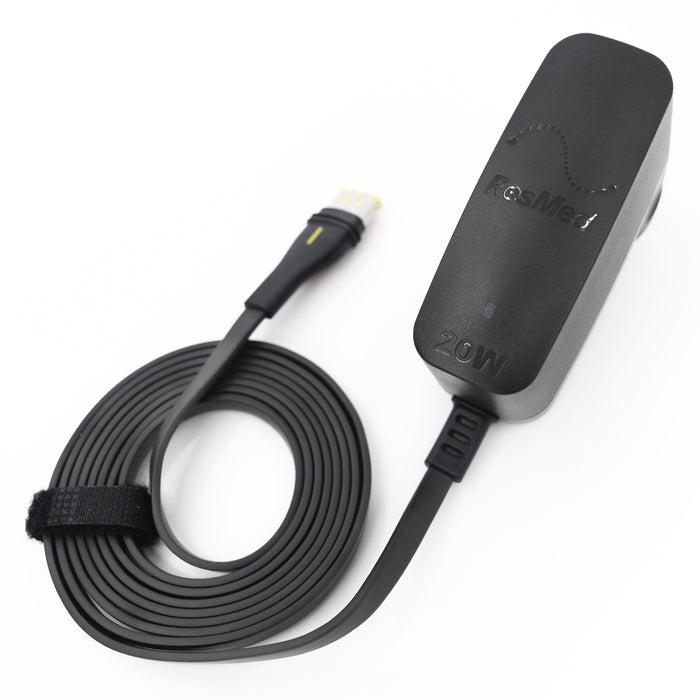 Black electronic device with cable on a white background