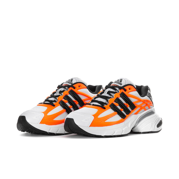 Pair of men's white and solar orange running shoes with black laces and stripe details