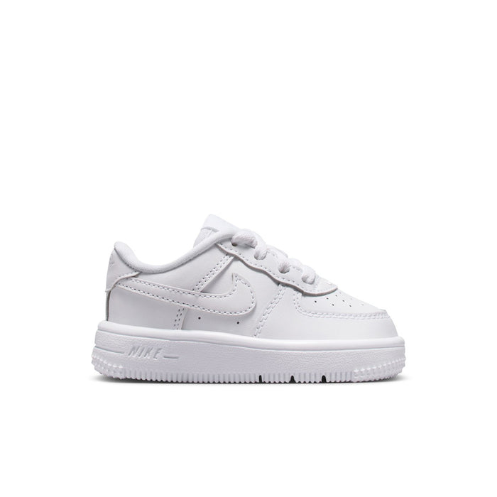 Toddler white low-top sneakers with Nike swoosh and lace-up closure