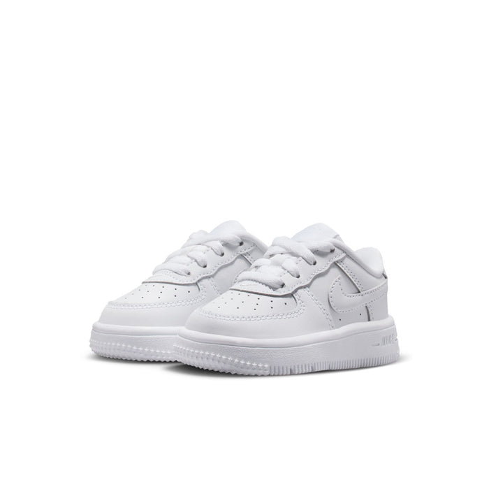 Toddler white low-top sneakers, side view with perforated toe and swoosh