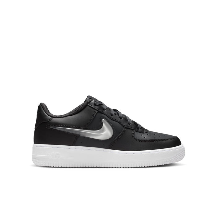 Youth low-top sneaker in dark leather with silver swoosh and white rubber sole