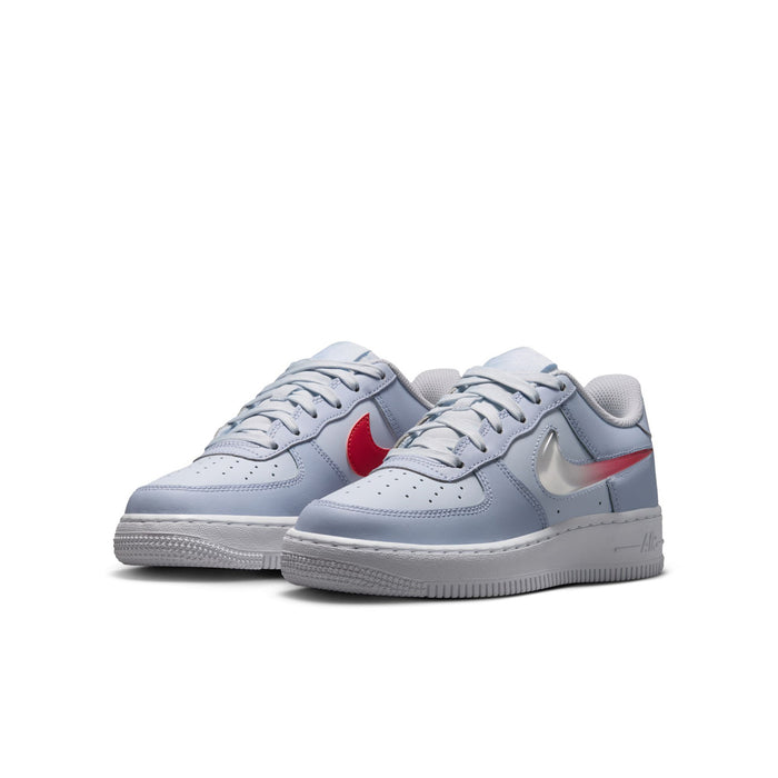 Youth low-top Nike sneakers, light blue-gray leather with white laces and red Swoosh