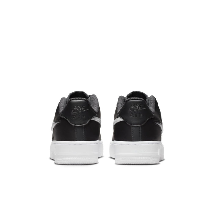 Youth low-top sneakers with rear pull tabs, dark leather, and white midsoles