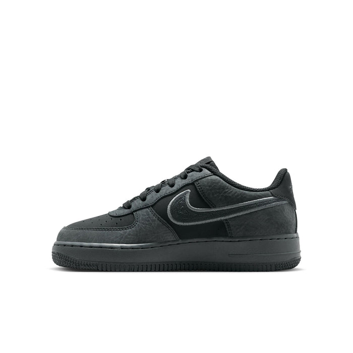 Air Force 1 LV8 youth sneakers in dark charcoal leather, side profile with swoosh