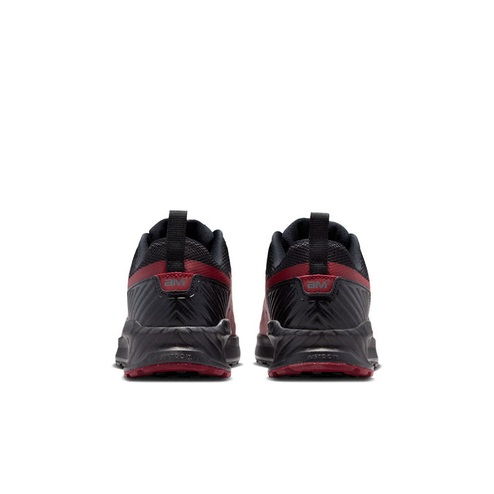 Youth sneaker pair, black uppers with red heel accents and Air unit at back