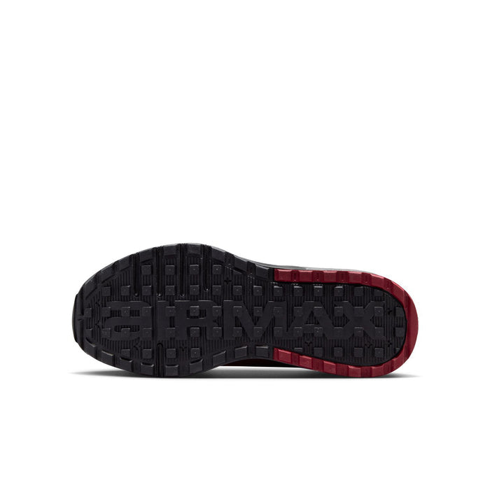 Youth outsole of black sneaker with red rim and textured traction tread