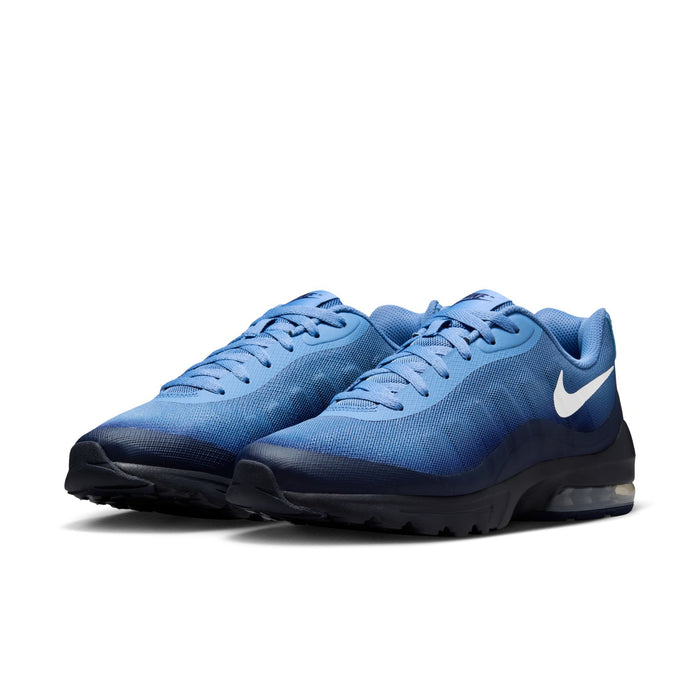 Pair of men's blue lace-up running shoes with white swoosh and cushioned air sole