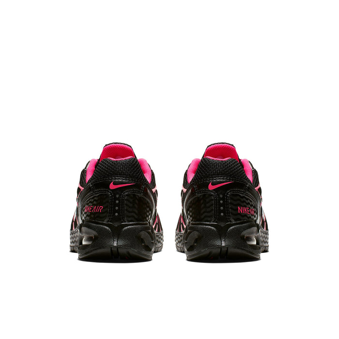 Women's black sneakers with pink heel collars and Nike Swoosh on back