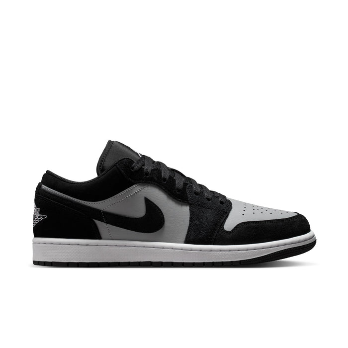 Black and white low-top sneakers with Nike swoosh and lace-up design