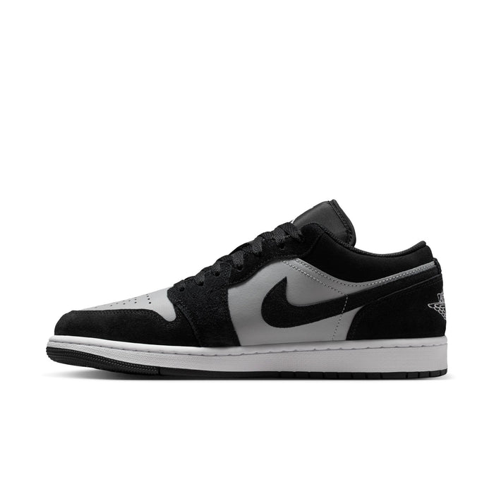 Black and white low-top sneaker with swoosh and lace-up front
