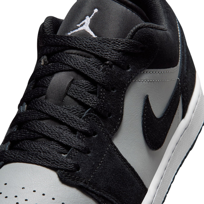 Black and white lace-up sneaker close-up with Nike swoosh and Jumpman tongue