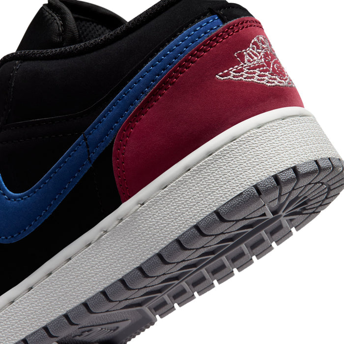 Air Jordan 1 low-top youth sneakers close-up: black and red side panel, blue trim, white sole