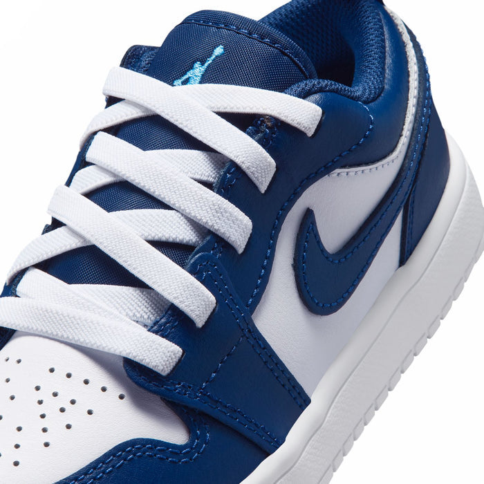 Kids' low-top sneakers close-up, navy and white with blue Swoosh and laces