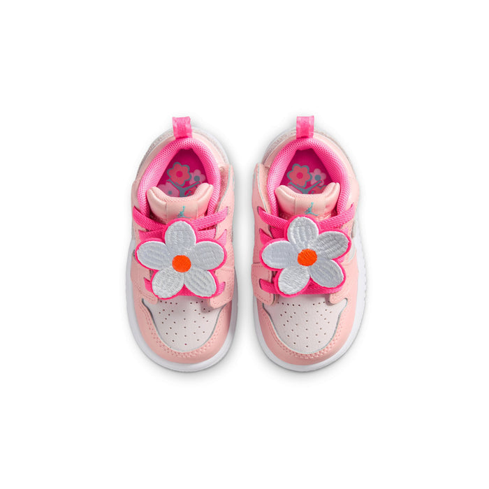 Pair of pink toddler sneakers with flower graphics on the inside and hook-and-loop straps