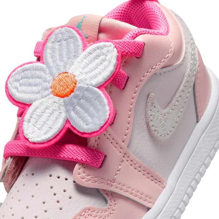 Close-up of pink and gray toddler sneaker with large flower patch and stitched overlays